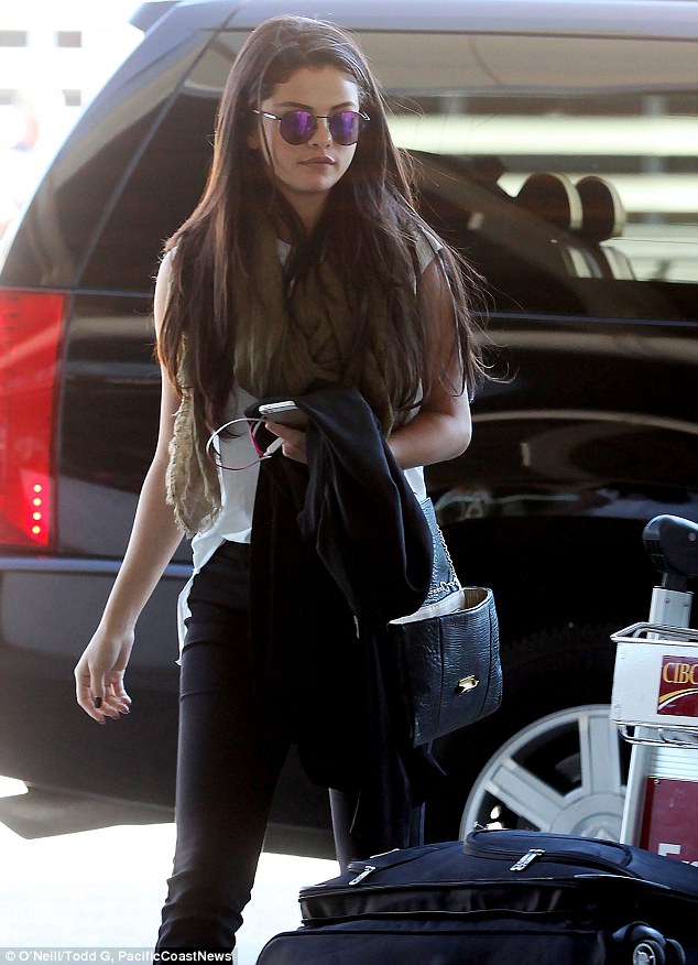 Downcast and Makeup Free Selena Gomez on Toronto Airport