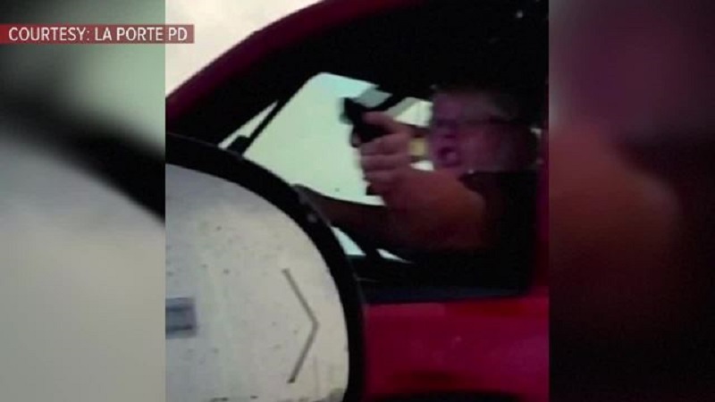 A Woman Driver raised Gun to get through traffic on a Highway